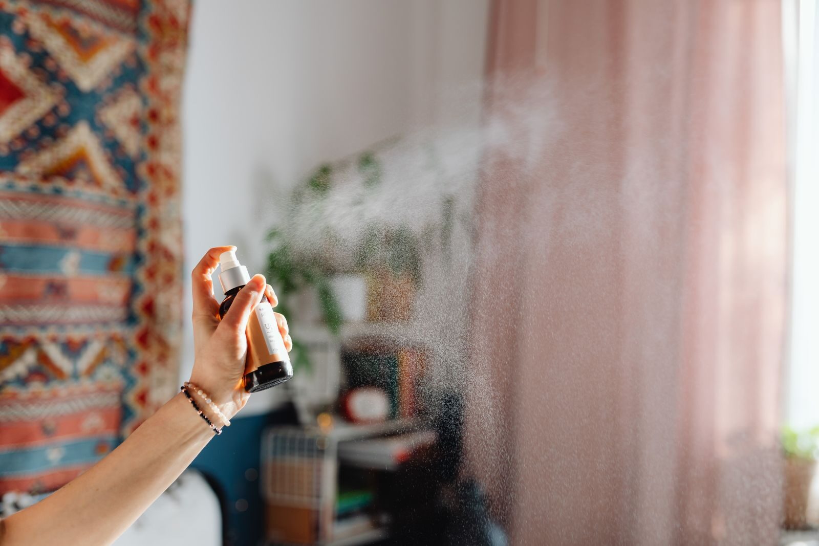 Spraying an air freshener in a room, which masks a mould smell but does not remove the mould