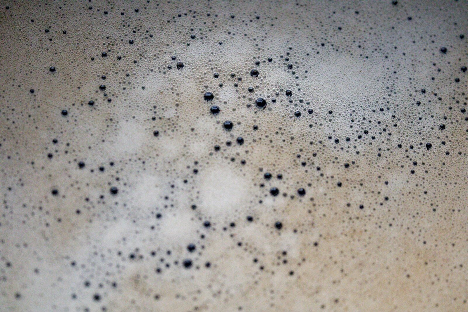 Close-up of foaming bubbles, the carbon dioxide released when vinegar and baking soda react and cancel out