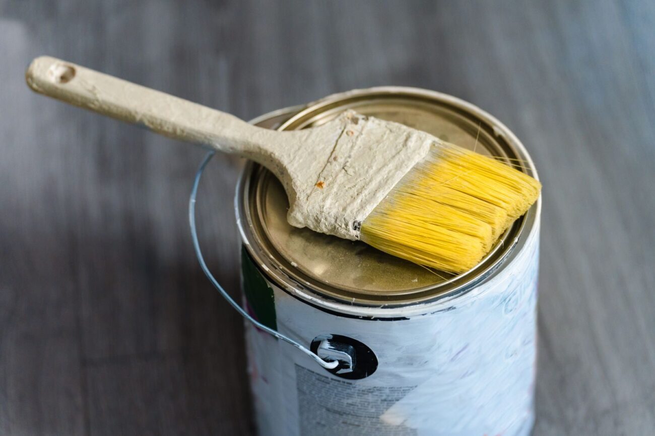 Paintbrush resting on an open paint can