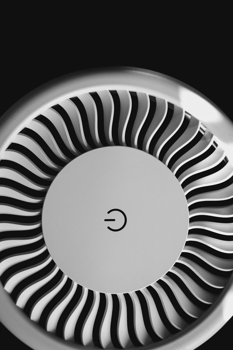 Close-up of an air purifier's swirl-patterned filter grille