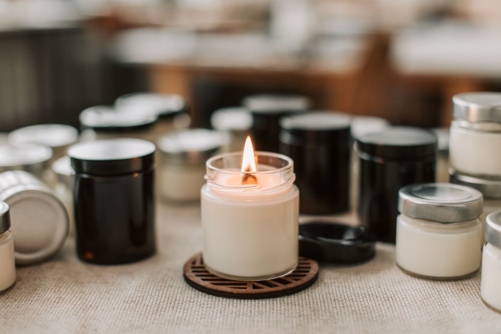 Lit soy candle with a trimmed wick