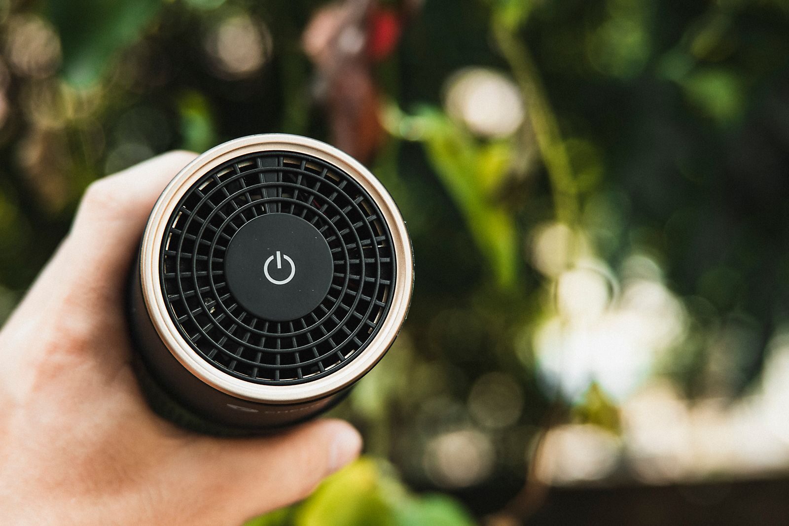 Compact electronic air ioniser device with visible power button