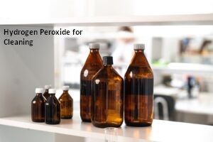 Amber glass bottles on a shelf with text reading hydrogen peroxide for cleaning